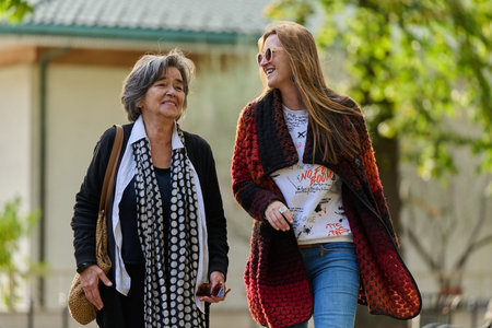 Autumn Walk: A Mother and Daughter Share Love and Support in Natures Embrace.