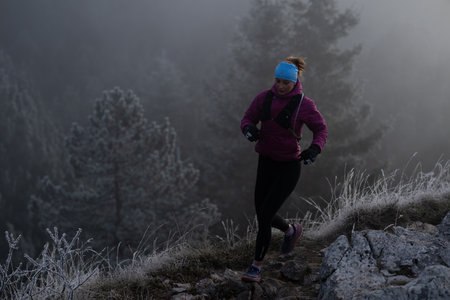trail running woman athlete training for ultra-marathon race in a mountainの写真素材