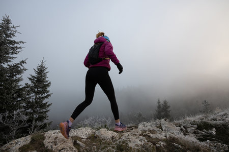 trail running woman athlete training for ultra-marathon race in a mountainの写真素材