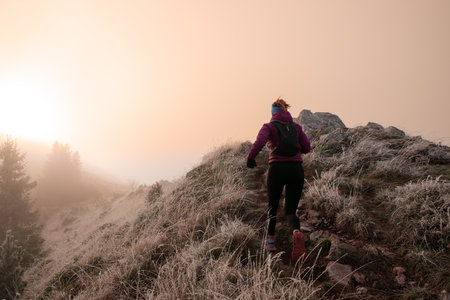trail running woman athlete training for ultra-marathon race in a mountainの写真素材