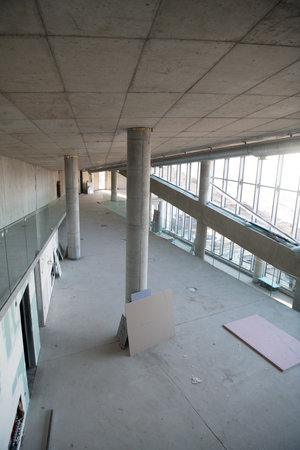 A captivating view of a modern business building under construction, showcasing its raw industrial...
