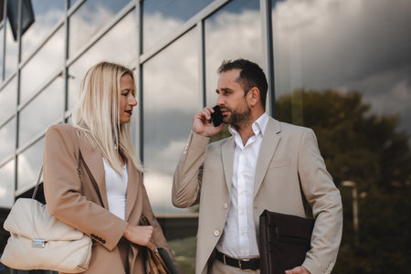 Modern business couple after a long days work, walking together towards the comfort of their home, embodying the perfect blend of professional success and personal contentment.の写真素材