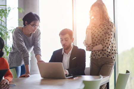 A diverse multiethnic business team engages in a collaborative meeting, discussing strategies and...