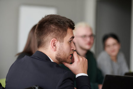 A diverse multiethnic business team engages in a collaborative meeting, discussing strategies and...