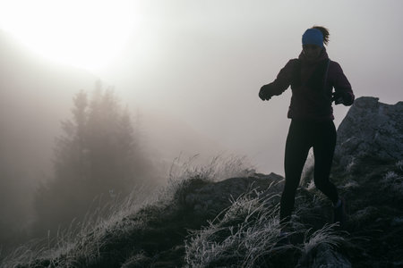 Trail Runner in Misty Mountain Landscape