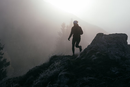 Trail Runner in Misty Mountain Landscapeの写真素材
