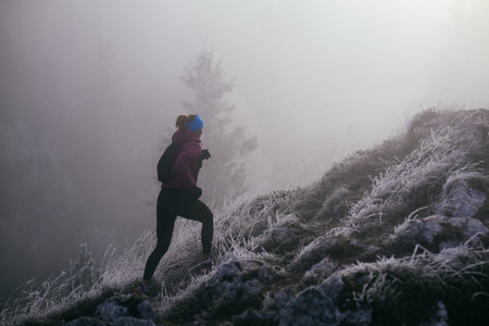 Trail Runner in Misty Mountain Landscape