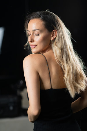Radiant Elegance: A Stunning Blonde in a Black Dress Exuding Confidence and Beauty.の写真素材