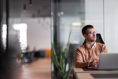 Businessman in glasses distracted from computer work look in distance thinking or pondering,...