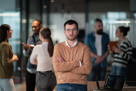 A successful business team working together in a modern startup office. Executives and employees collaborate, brainstorm, and showcase teamwork, leadership, and innovation in a confident, dynamic environmentの写真素材