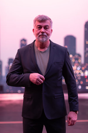 Confident Businessman Unbuttoning Suit in an Urban Cityscape.の写真素材