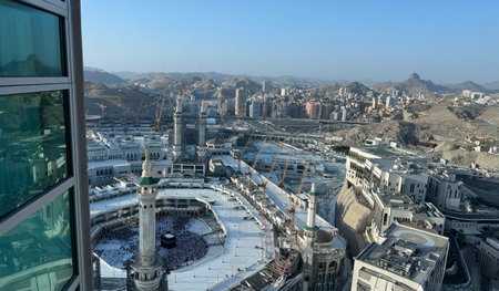 Aerial view of Masjid Al-Haram and Makkah city from the Clock Tower, Pilgrims performing Tawaf around the Kaaba during Hajj or Umrah, Magrib pray. The Holy Mosque, Minarets, and skyline highlight this sacred Landmarkの写真素材