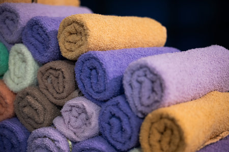 Neatly folded colorful towels arranged in a hospital room, providing comfort and hygiene for patientsの写真素材