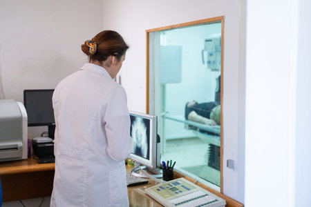 Radiologist Analyzing X-Ray Scans in a Medical Imaging Room.の写真素材