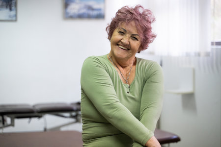 Smiling Elderly Woman in Physiotherapy Roomの写真素材