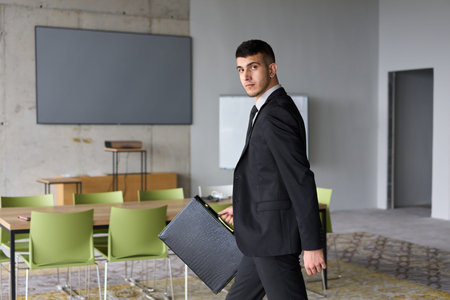 A determined businessman in a black suit confidently walks through the office, embodying...