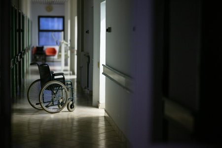 Empty Wheelchair in Hospital Hallwayの写真素材