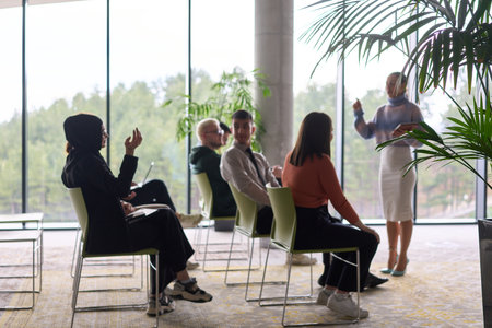 A businesswoman leader guiding a meeting with her colleagues, discussing business challenges, marketing strategies, and new plans for growth and successの写真素材