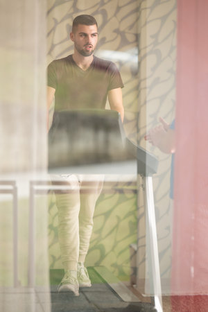 Treadmill Walking Therapy Session.Patient visible through glass walking on treadmill as part of rehabilitation treatment.の写真素材