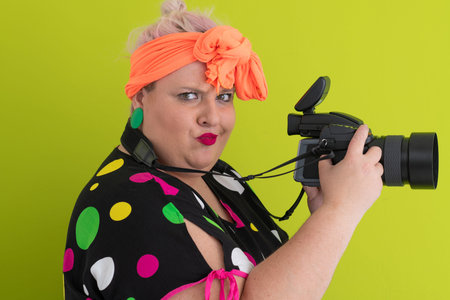Side view of woman filming with video camera