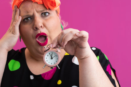 Playful woman in colorful outfit pointing with excited expression