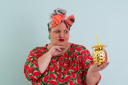 Funny woman in watermelon dress making silly confused gestureの写真素材