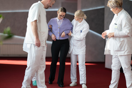 Medical team helping patient with walking therapy