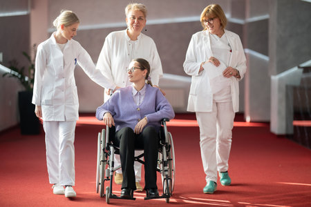Doctor checking patients progress in wheelchairの写真素材