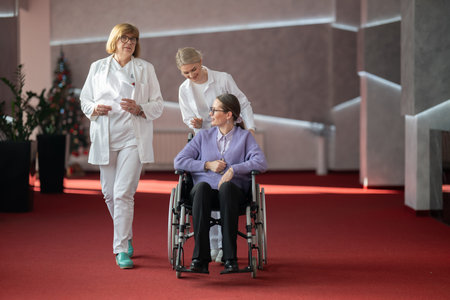 Doctor checking patients progress in wheelchairの写真素材