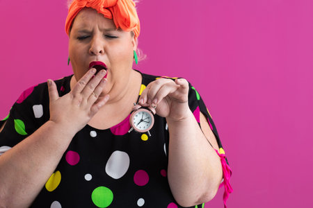 Playful woman in colorful outfit pointing with excited expression