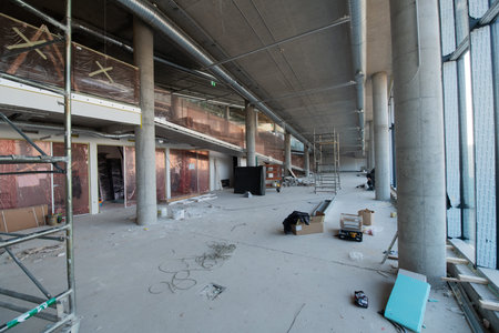 A captivating view of a modern business building under construction, showcasing its raw industrial...