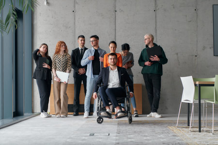 A diverse group of business professionals walking together through the office, symbolizing unity and...