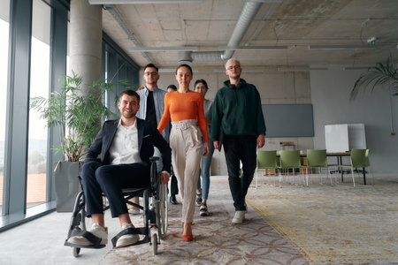 A diverse group of business professionals walking together through the office, symbolizing unity and...