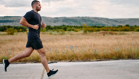 Athletic Man Jogging in the Sun, Preparing His Body for Lifes Extreme Challenges