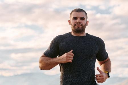 Athletic Man Jogging in the Sun, Preparing His Body for Lifes Extreme Challenges