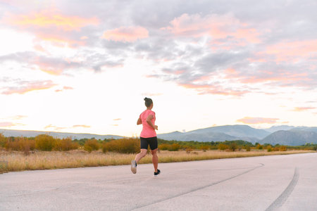Determined Athlete Running in the Sun amidst Beautiful Nature