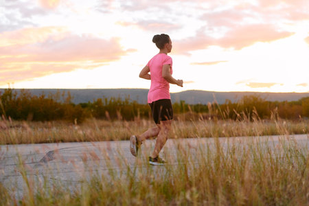Determined Athlete Running in the Sun amidst Beautiful Nature