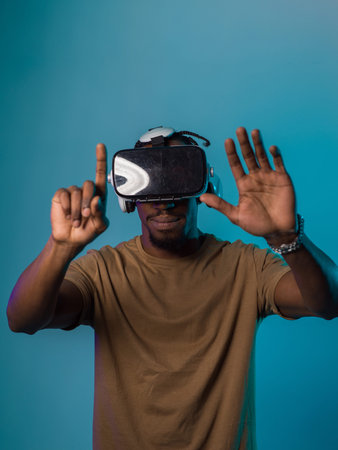 Immersed in a digital realm, an African American man navigates the virtual landscape with a VR...