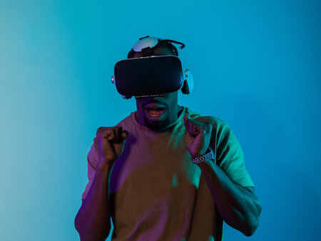 African American man immerses himself in a thrilling horror gaming experience using VR glasses,...