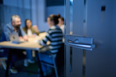 Smiling confident businessman leading a creative meeting in a modern office, symbolizing leadership, teamwork, collaboration, and success in a professional business environment.の写真素材
