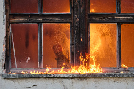Burning building, flames engulfing an old window, fire disaster, destruction and danger, emergency...