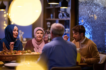 Muslim family enjoying iftar together during Ramadan in a warmly lit restaurant