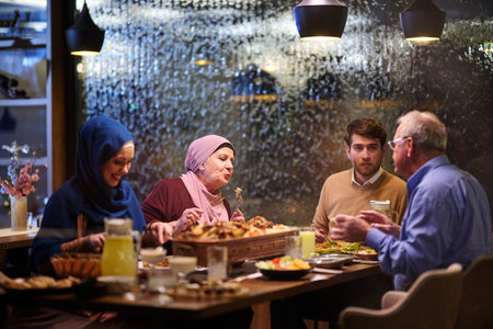 Family enjoys iftar together in warm restaurant with Ramadan decorations and traditional foods