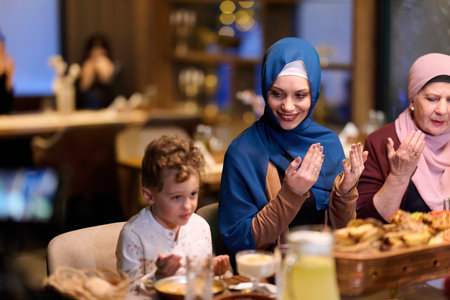 Muslim family enjoys iftar together in a restaurant decorated for Ramadan celebration