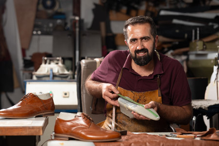 Cobbler at work in a leather workshop, crafting and measuring high-quality shoes