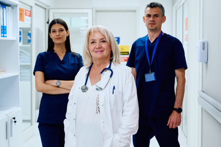 Team of healthcare professionals in a modern hospital corridor during a busy shiftの写真素材