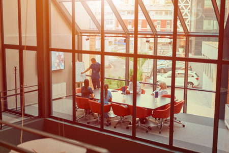 Team collaborates in a modern conference room during a productive business meeting in an urban...