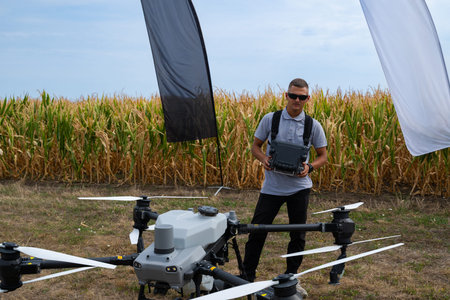Drone pilot with agricultural drone setup in a cornfield during an outdoor shoot