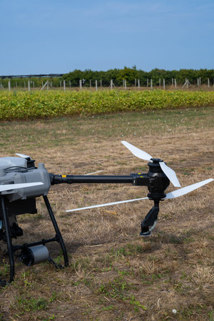 Aerial agricultural drone on a dry field with propellers ready for precision farming and modern...