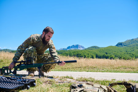 Military Sniper Soldier Preparing Rifle in Open Field Landscape
